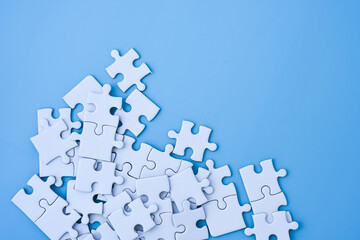 White jigsaw puzzle on blue background.
