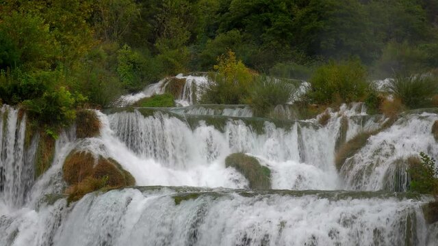 Closer up view of a series of waterfalls with blowing mist at Krka National Park in Croatia