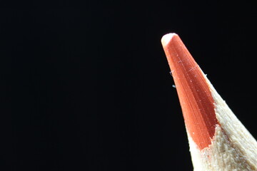 Macro view of the tip of the pencil on a black background.