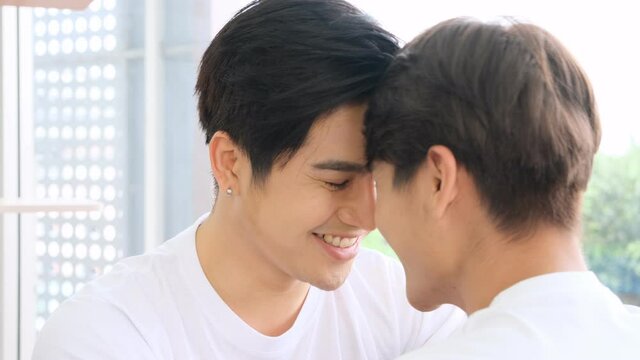 Asian gay lgbt couple looking into each other's eyes and kiss happily together,homosexual and lgbt concept.