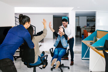 young Mexican business professionals having fun in creative office in Mexico city