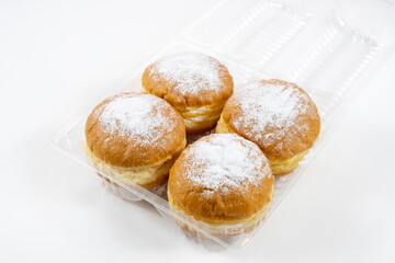 Close-up of donuts , Berlin pancakes, dusted with powdered sugar served on a rustic wooden table