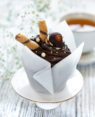 Chocolate cupcakes on white wooden background