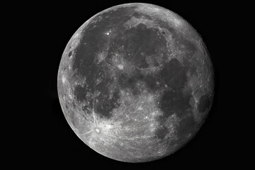 Photo of the moon through a telescope. Moon with craters on a dark background.