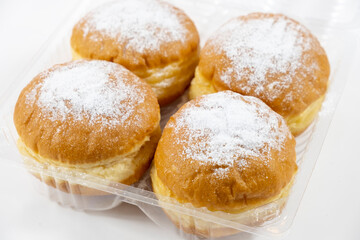 Close-up of donuts , Berlin pancakes, dusted with powdered sugar served on a rustic wooden table