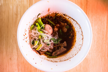Popular street food in Thailand (Kuai Tiao Moo Namtok) that consisted of pork ball, pork meat, basil or thyme, bean sprouts, morning glory, noodle and creamy soup.
