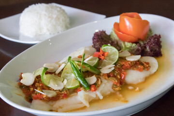 Steamed Thai dory fish with lime, chili and garlic served with steamed rice