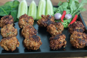 Thai minced pork balls with roasted rice called Larb Moo Tod