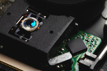 Closeup of a laser head and dvd rom drive with boards. Writing and reading with laser technology