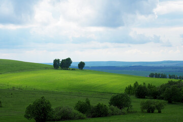 Summer landscape of the countryside. Cloudy day. Valley among the hills.