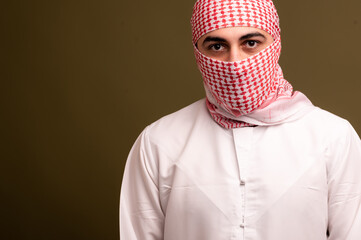 Muslim man. Portrait of a young arab man in traditional dress. 