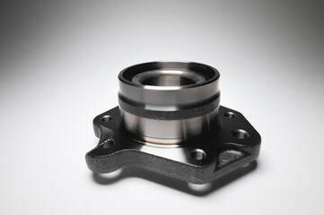 New wheel bearing in a metal housing on a black-white gradient background. New car suspension parts