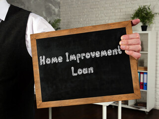 Business concept meaning Home Improvement Loan with sign on the piece of paper.