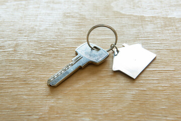 Home key with home key ring on wooden background