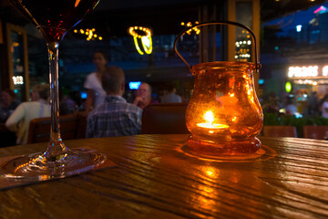 Candlelight on wooden table in a bar