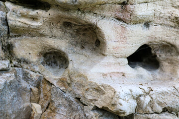 Naklejka premium mountain textures of stones with interlayers of gypsum, colored quartz, clay, sand and other layers of various ores, with different textures, color and density, in gypsum ore quarry.