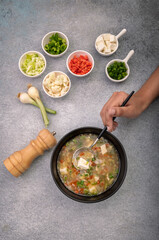 girl preparing vegetable soup with ingredients