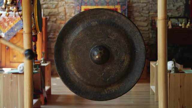 Asian religious metal gong sounded to alert monks of prayer time - religion, tradition and lifestyle concept