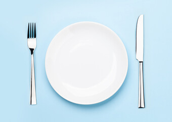 Empty plate, fork and knife