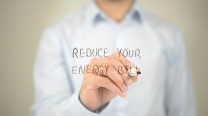 Reduce Your Energy Bill, man writing on transparent screen