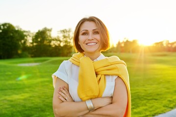 Outdoor portrait of positive confident mature woman