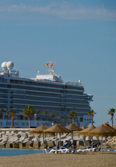 Huge modern Costa cruiseship or cruise ship liner in port of Malaga in Spain with cruise terminal...