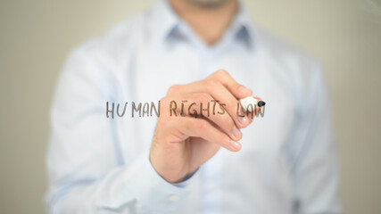 Human Rights Law, man writing on transparent screen