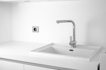 Modern bathroom interior with sink and chrome faucet.