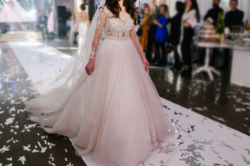 Fototapeta premium Bride at ceremony in wedding day. Woman in an expensive, luxury dress, details of models walking on the collection catwalk during the Bridal Week runway.