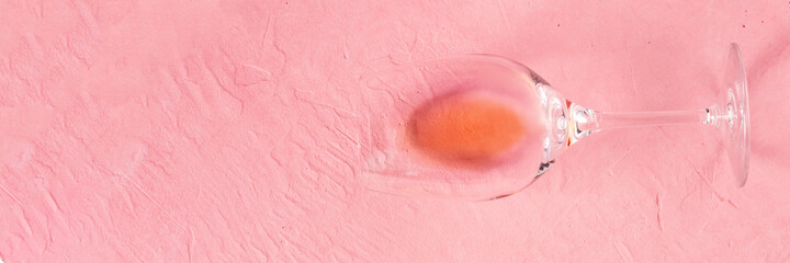 Rose wine panorama, shot from above on a pink background with a place for text or logo