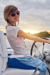 Young caucasian woman sailor enjoying summertime.