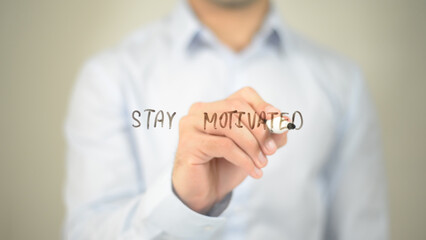 Stay Motivated, man writing on transparent screen