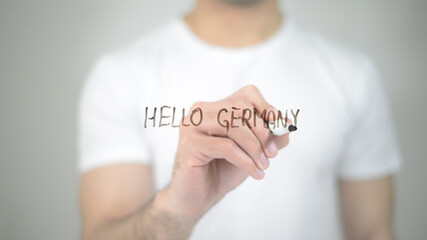 Hello Germany, man writing on transparent screen © stockbakers