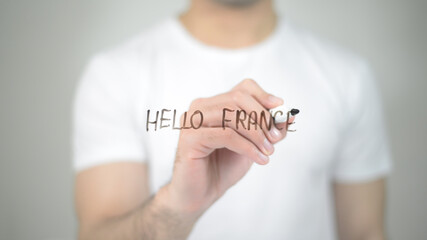 Hello France, man writing on transparent screen