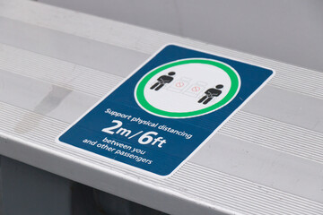 View of sign "Support physical distancing 2 metres between you and other passengers" on ferry in Vancouver.