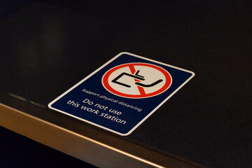 View of sign "Support physical distancing. Do not use this workstation" on ferry in Vancouver