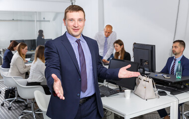 Chief stretching open hand offering handshake and inviting to cooperation in modern office