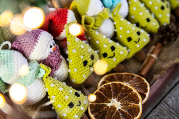 A set of handmade Christmas tree toys crocheted in a wooden tray with burlap. Country style.