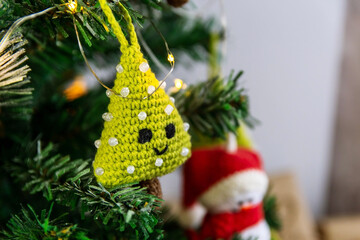 Amigurumi herringbone on a Christmas tree. Concept of creativity before christmas and new year.