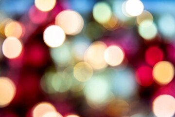 Fototapeta premium Gold and red bokeh abstract background with defocused lights and Christmas balls.
