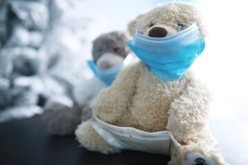 Teddy bears wearing protective mask. Coronavirus protection. Toy bear in mask to prevent virus spread. Copy space.