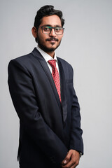 Successful Young indian business man posing over white background