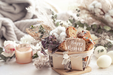 Happy Easter composition with pieces of Easter cake in a decorative basket and eggs.