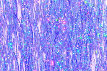 festive holographic tinsel fringe detail on purple background