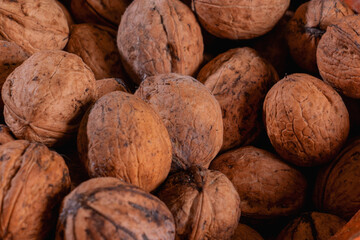 Natural walnut background pattern texture. Abstract walnuts heap pattern background. Walnuts with shells.