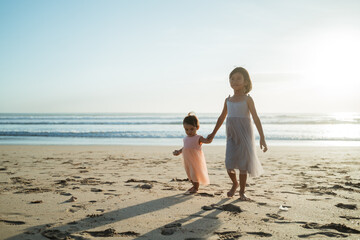Fototapeta na wymiar Portrait of a little sister's child enjoying a vacation on the beach