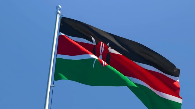 The national flag of Kenya is flying in the wind against a blue sky