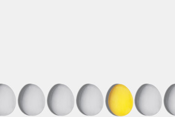 Gray and yellow eggs in the color of the year 2021 on a light background copy space