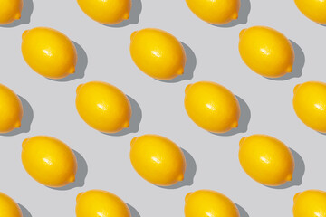 Seamless pattern of yellow lemons in the color of the year 2021 on the ultimate gray color