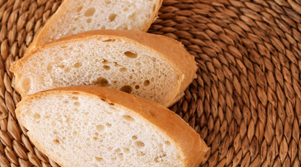 Pieces of loaf are fanned out on a wicker background.